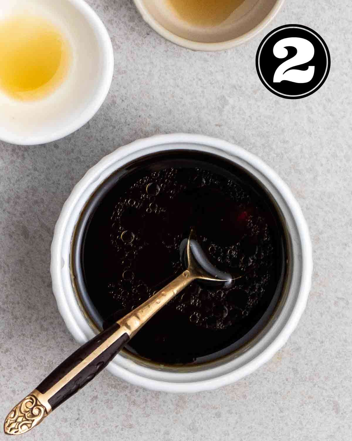 Seasonings for filling in a ramekin with a teaspoon beside.