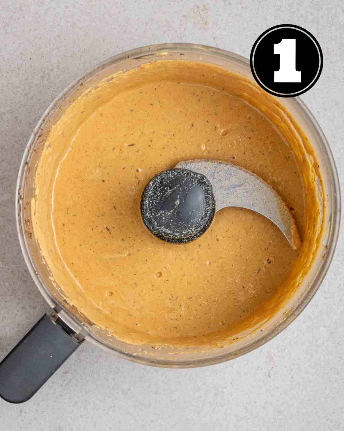 Wet ingredients of sausages in a food processor.