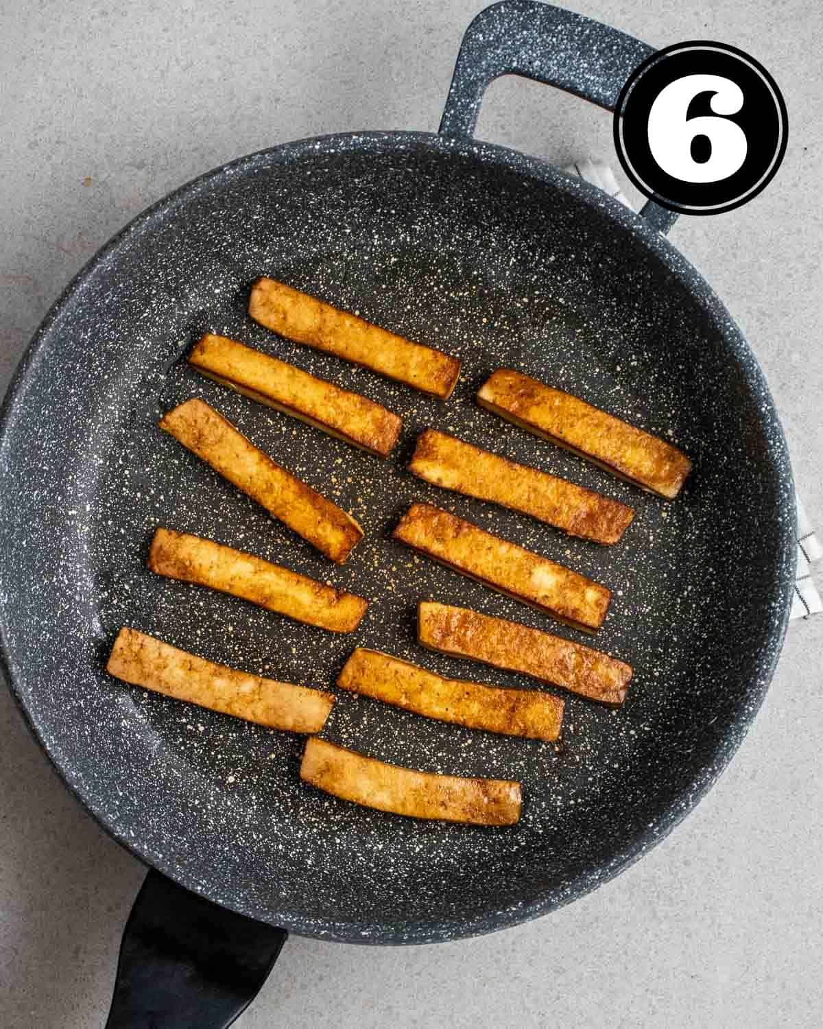 Cooked tofu in a pan.