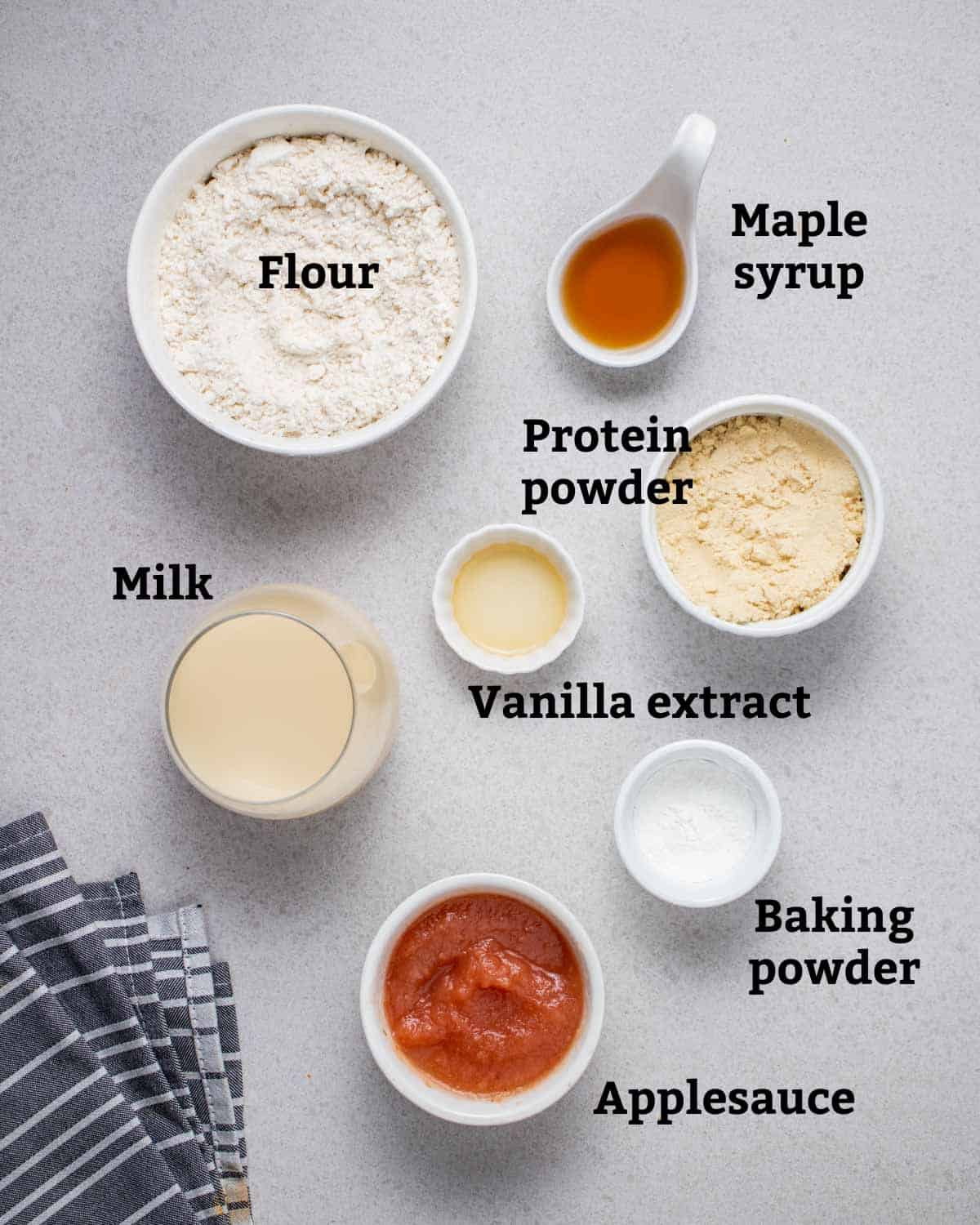 Ingredients needed for pancakes including flour, protein powder, milk, and applesauce.