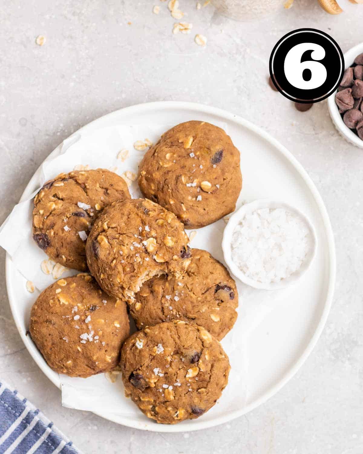 A plate of protein cookies with a small dish of sea salt flakes beside.