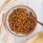 A bowl of cinnamon chickpeas with a wooden spoon beside.