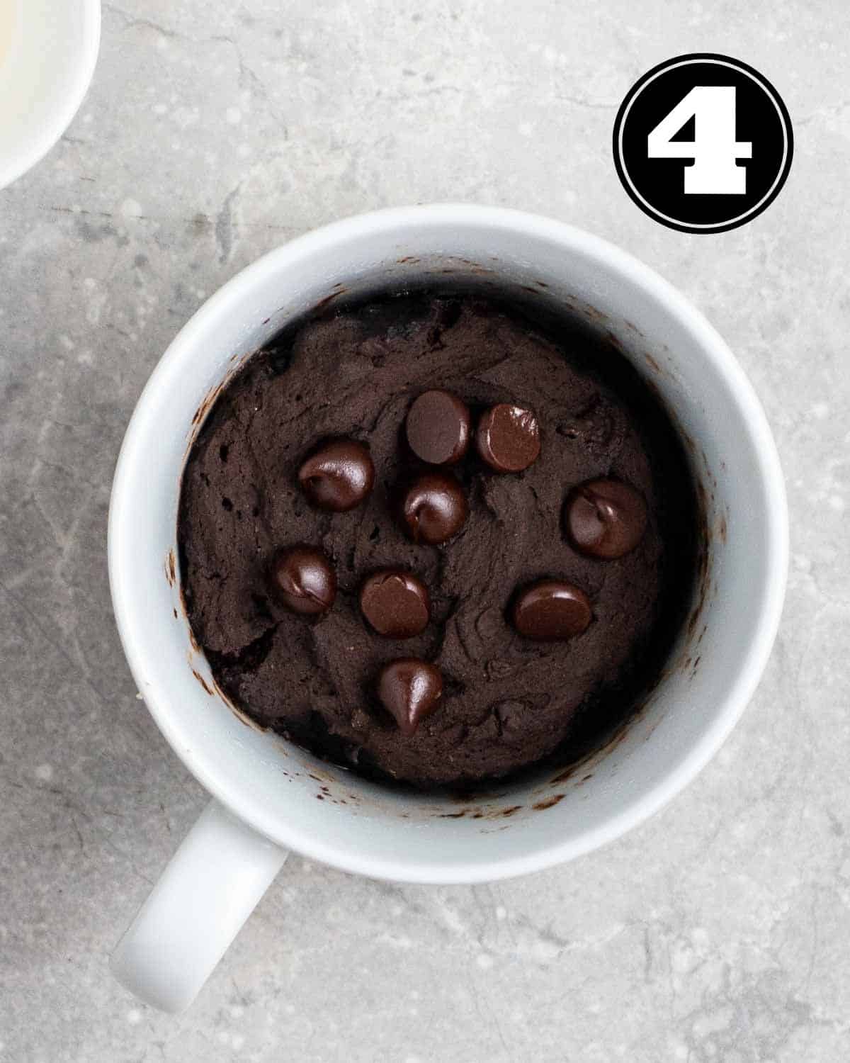 Mug cake with an empty ramekin beside.