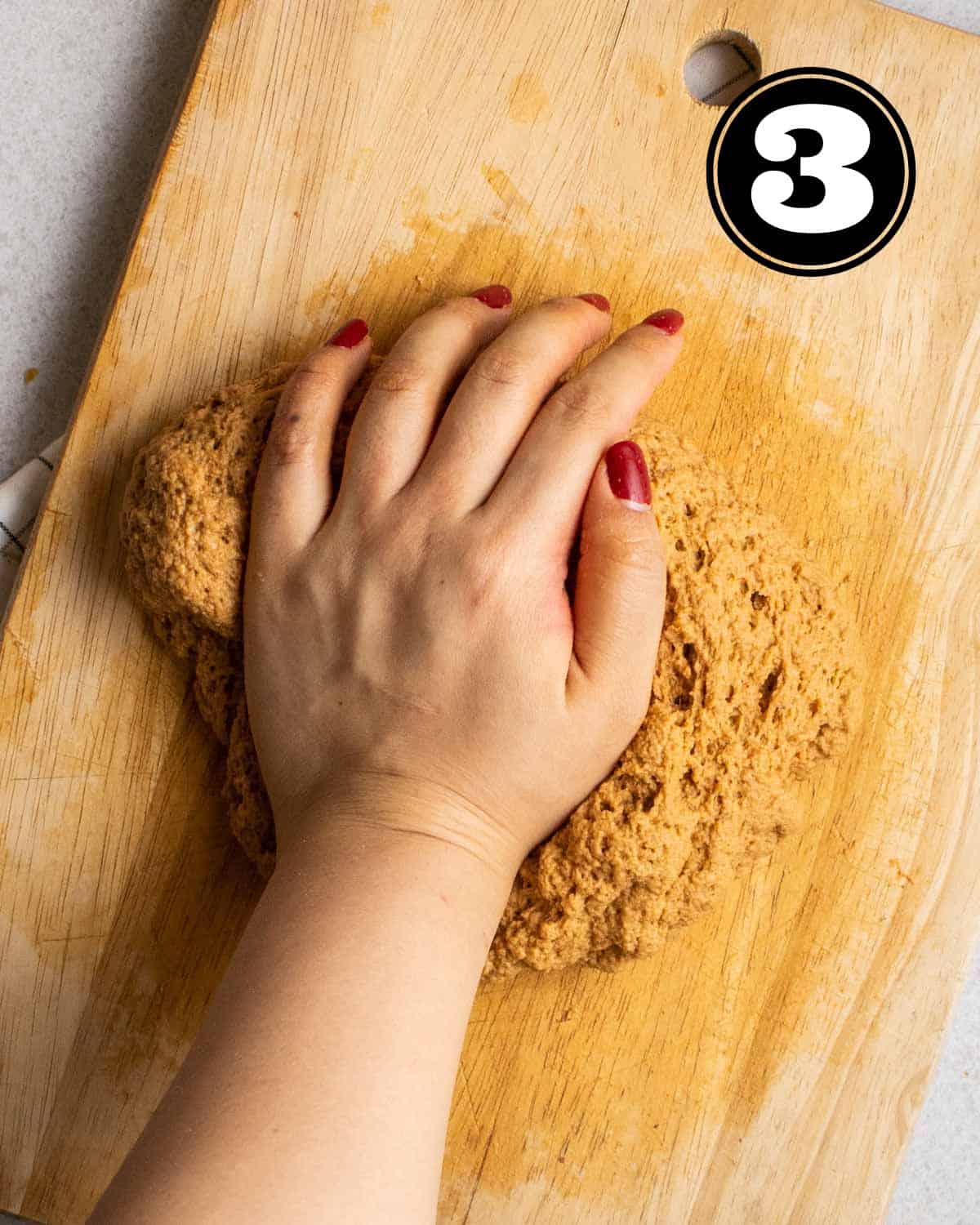 Kneading dough on a wooden board.