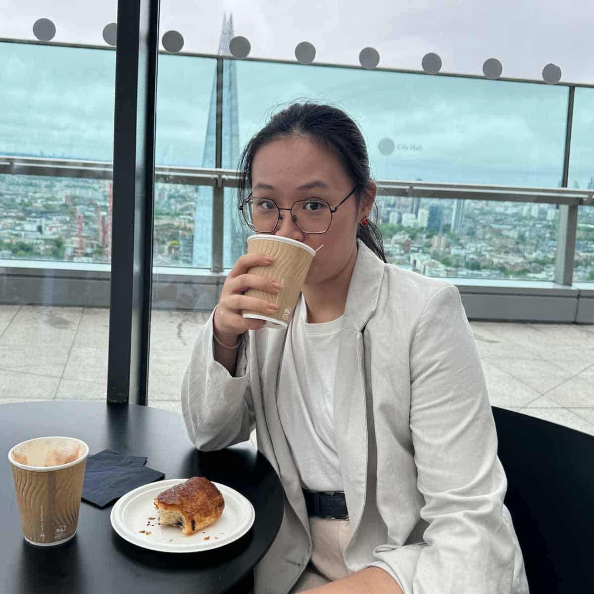 Mee Sha drinking a cup of coffee.