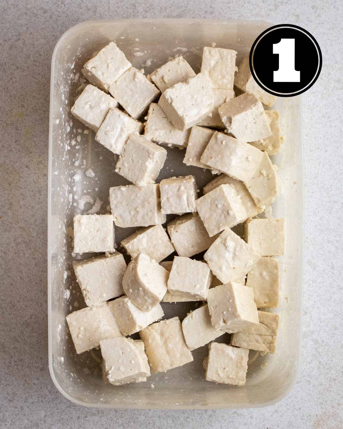 Coated tofu in a container.