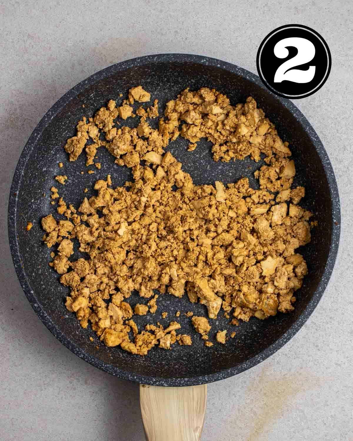 Cooked tofu mince in a non-stick pan.
